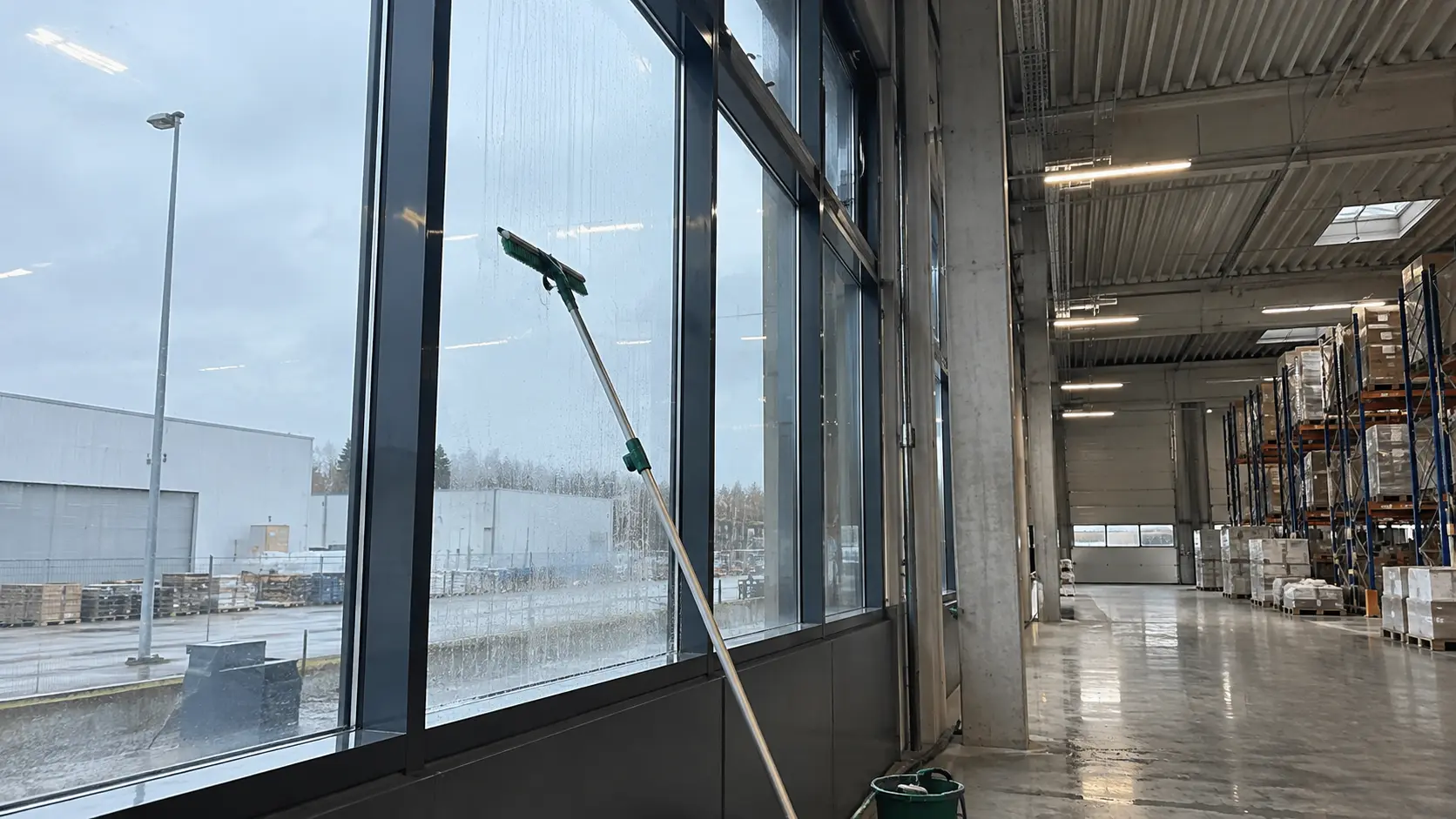 Fensterband einer Lagerhalle wird mit der Teleskopstange gereinigt in Soest